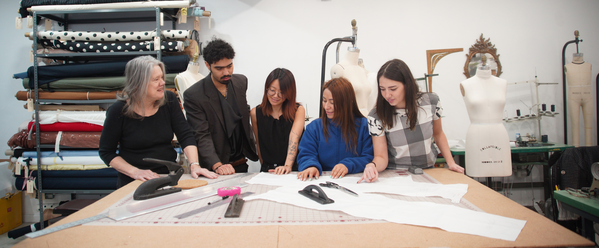 Image of Elizabeth and the CPS staff - Esteban, Thea, Sandra, and Lizzy -  around a design table in the CPS studio.